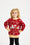 Un enfant mignon pose vêtu d'un pull de Noël rouge portant l'inscription